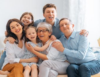Nice girls, their mother, father, grandfather and grandmother are enjoying spending time together at home. Family time.